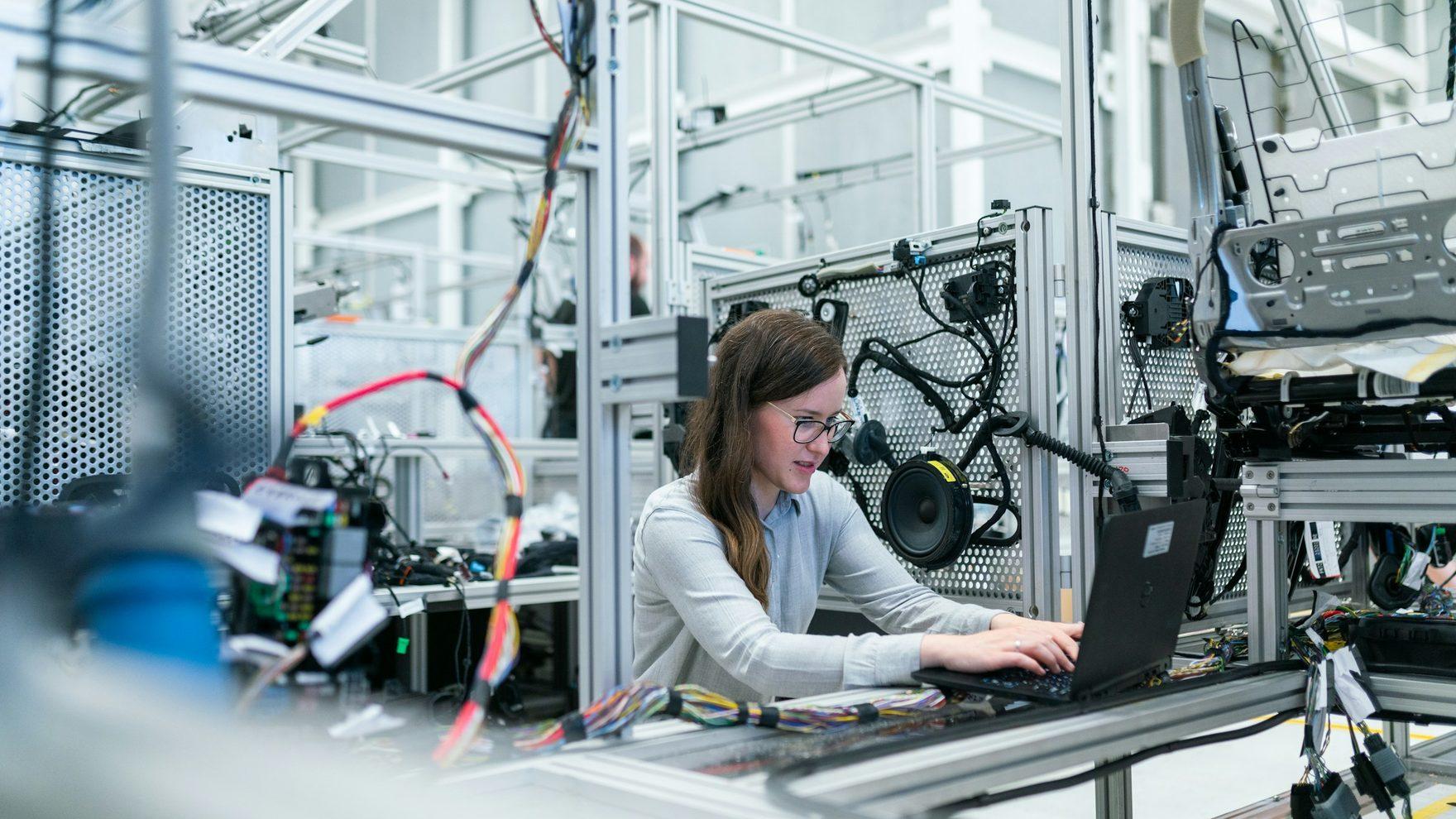 An engineer working on an industrial automation line