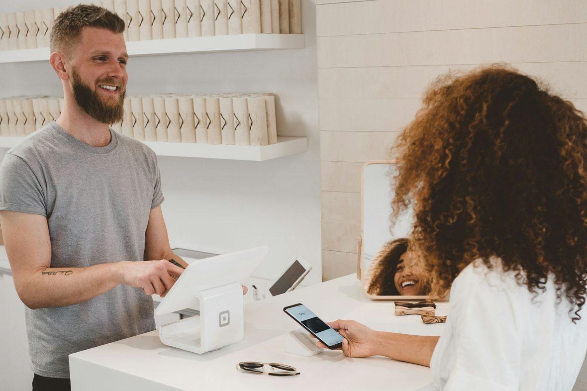A staff member helping a customer at a service counter