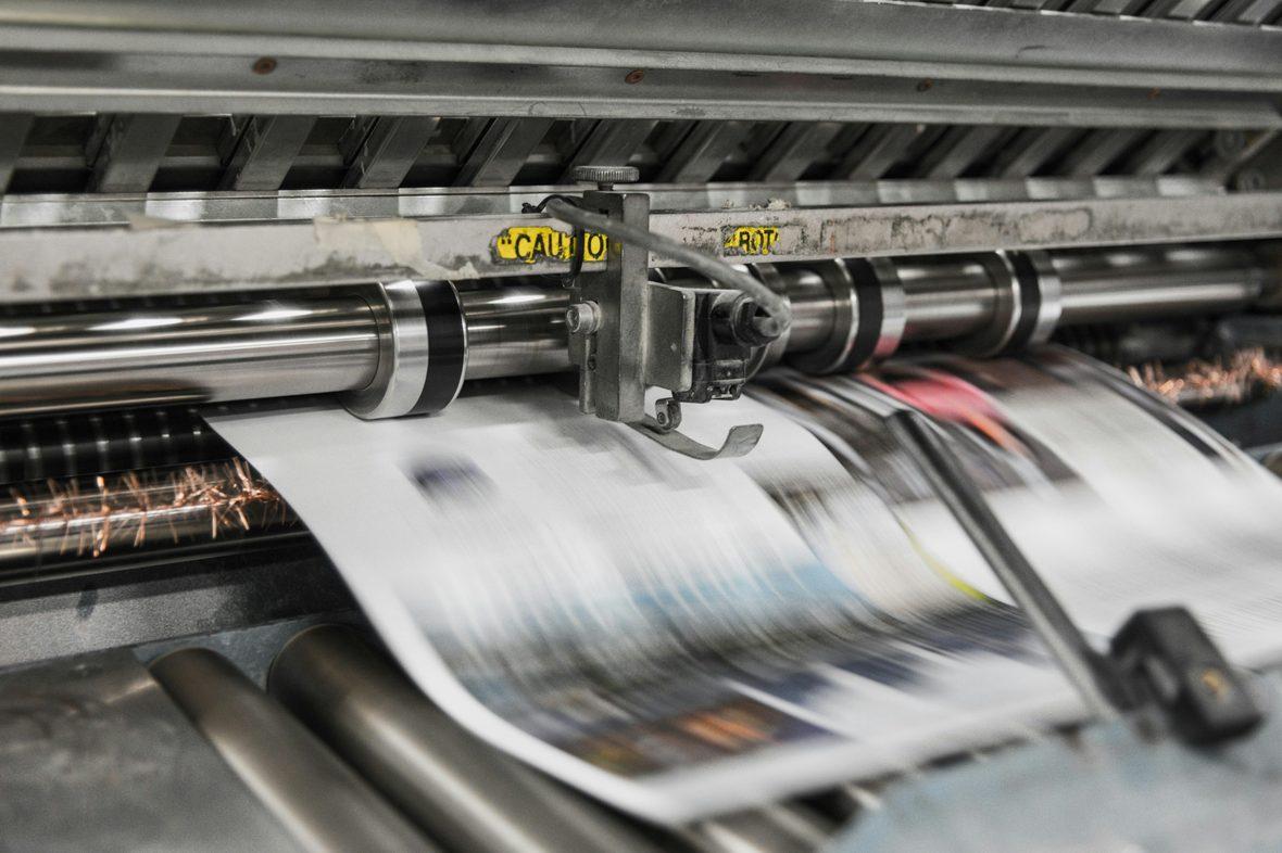 A production press running printed output at speed