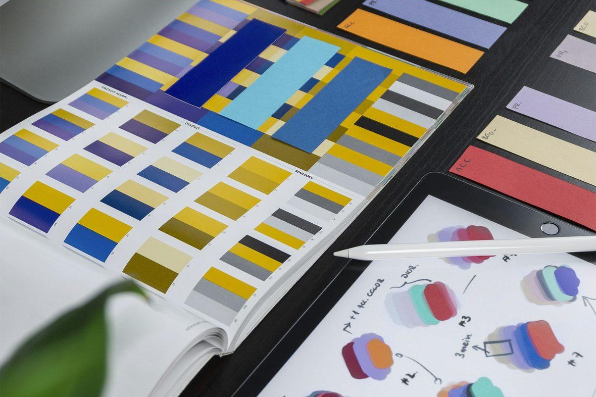 Printed colour swatch cards fanned across a desk