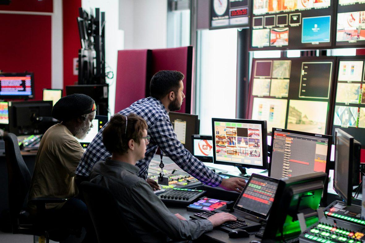 An operations room with live data on multiple screens