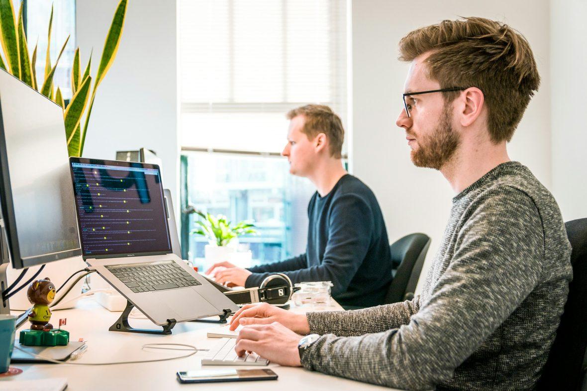Engineers working at desks in a bright office