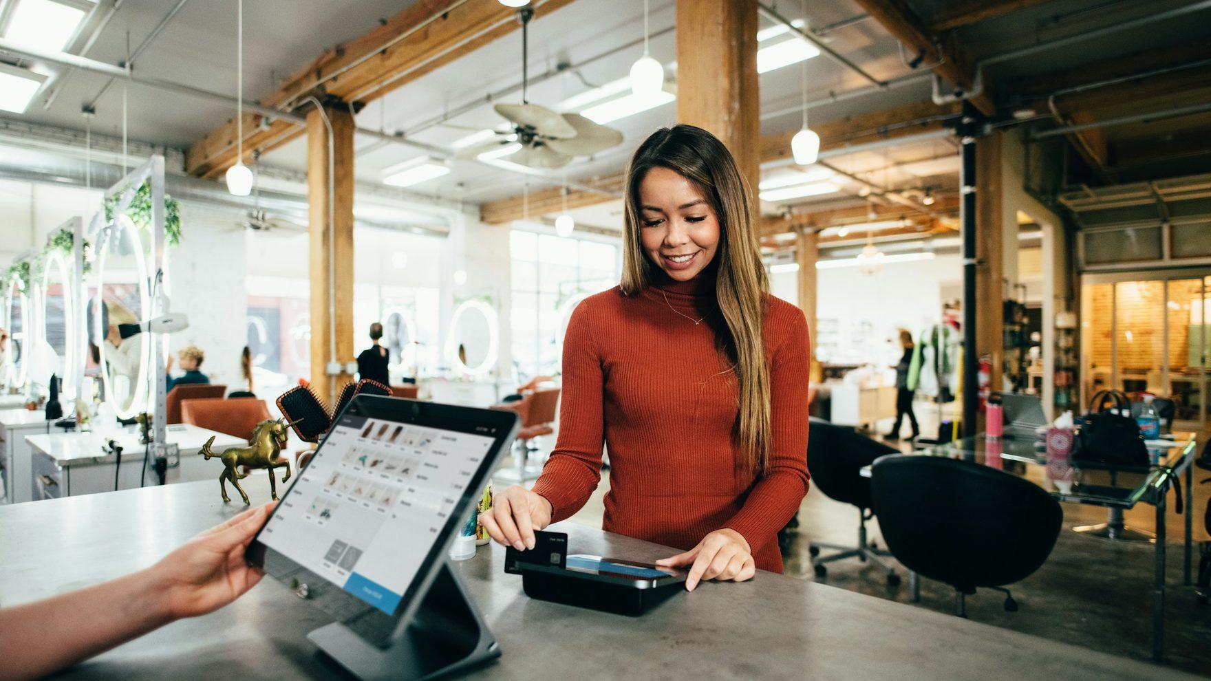 A shop owner running the business from a tablet at the counter